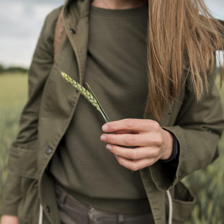 close-up-traveller-outdoors-holding-wheat