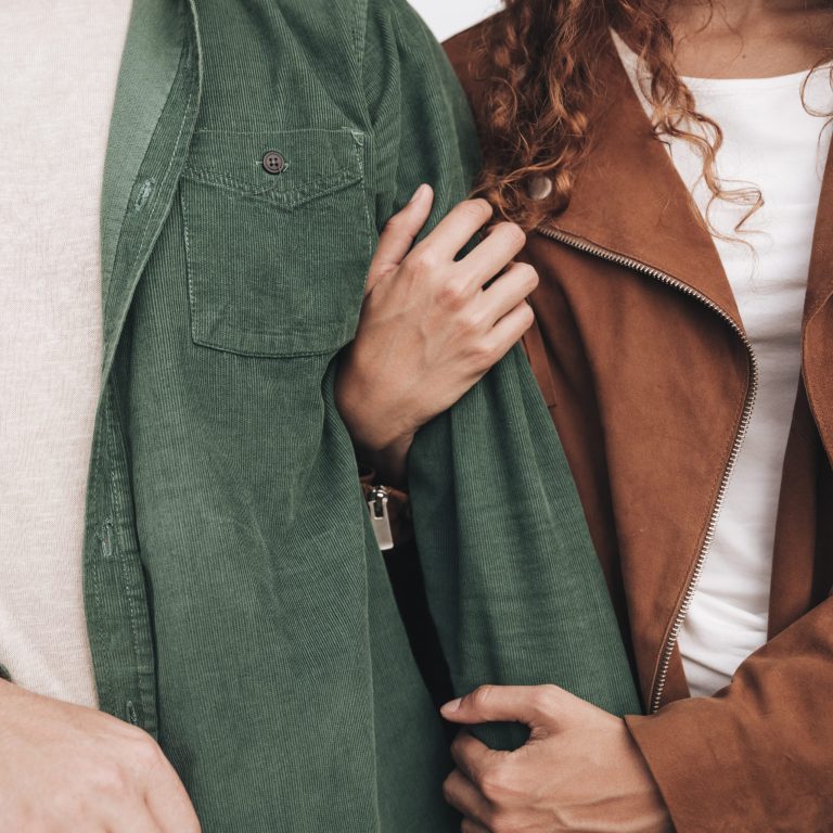 close-up-woman-holding-man-arm
