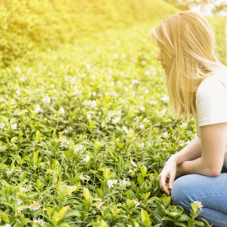 lady-sitting-near-green-grass